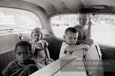 On Main Street,  East Feliciana Parish,  Louisiana  1963-I ran across these children in a car near the Voter Registrar's Office during the Freedom Summer of 1964.  They weren't waiting  for someone who was registering but for a black domestic to finish the family's shopping.
