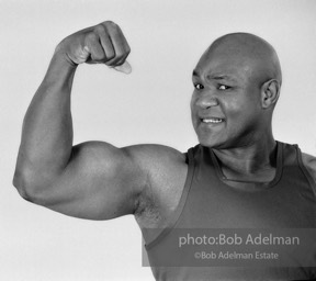 The Champ: heavyweight boxing champion George Foreman, New York City.  1995


“During a break, Foreman told me that he was saved by a ‘benevolent society.’ He had been
doing poorly in school and was getting into trouble. Fearing police were looking for him,
he hid under his family’s home and covered himself in sand, breathing through a straw.
There had to be a better way. His salvation was a government-sponsored anti-poverty
boxing program, the Job Corps, that led to his Olympic gold medal and eventually the World Championship.