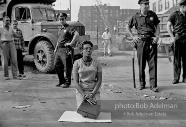 Stop action: Determined to end unfair hiring practices, two protestors put their lives on the line, closing down a construction site at the Downstate Medical Center, Brooklyn, New York City. 1963
