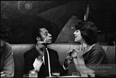 James Baldwin and school teacher (not idetified) at El Toro's restaurant. 1964.
