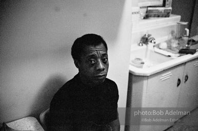 James Baldwin in his New York City apartment. 1964.