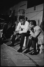 While writing a story for LOOK magazine, writer James Baldwin talks with Sidney Poitier on the set of  the film 'For Love of Ivy', 1968.S