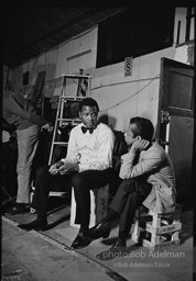 While writing a story for LOOK magazine, writer James Baldwin talks with Sidney Poitier on the set of  the film 'For Love of Ivy', 1968.S