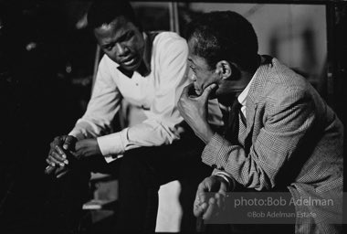 While writing a story for LOOK magazine, writer James Baldwin talks with Sidney Poitier on the set of  the film 'For Love of Ivy', 1968.