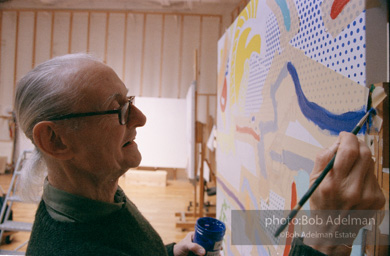 Roy Lichtenstein at work on his painting Interior with Ajax. 1997.-photo©Bob Adelman, artwork ©Estate of Roy Lichtenstein