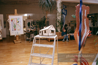 Roy Lichtenstein drawing in his NYC studio. House I maquette (center), Interior with Woman (left, on easel).1997-photo©Bob Adelman, artwork ©Estate of Roy Lichtenstein