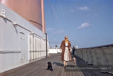 Grace Kelly walking her dogs on the decks of the Constitution during her Voyage to Monaco, April 1956.