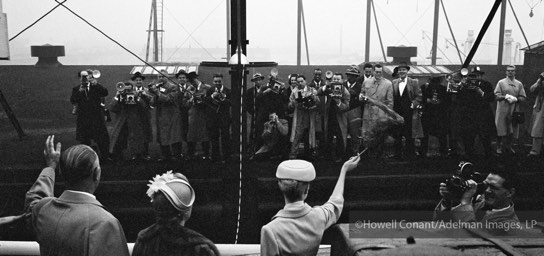 Grace Kelly along with her father and mother wave to a mob of photographers clustered on New York’s Pier 84 as the Constitution set sail on April 4, 1956.