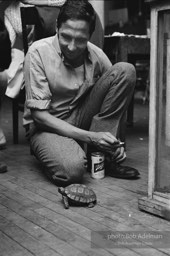 Robert Rauschenberg plays with pet turtle during a party at his New York loft. New York City, 1966.The turtle, Rocky,