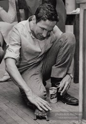 Robert Rauschenberg plays with pet turtle during a party at his New York loft. New York City, 1966.The turtle, Rocky,