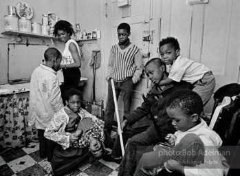 Eartha Holman, a single mother on welfare, lived with her eight children in a three-room, fifth-floor walk-up, Harlem, New York City.  1966