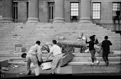 Payback: Dramatizing their rage at the city’s neglect, residents of the Bedford Stuyvesant neighborhood dump their street refuse on the steps of Brooklyn Borough Hall, New York City.  1963
