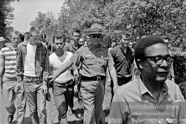 “It’s dues time. Activist Bob Gore is being trailed by a mob. The Freedom Walkers are about to be arrested at the Alabama state line simply for walking on the side of the road.”


Freedom Walkers retrace the route of a slain black postman, Highway 11 near the Georgia-Alabama border.  1963