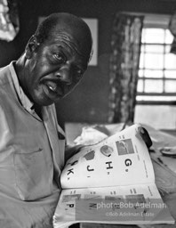 Getting the word: Ollie Robinson, an unemployed farmworker, learns to read,  the Mississippi Delta, Mississippi.  1965