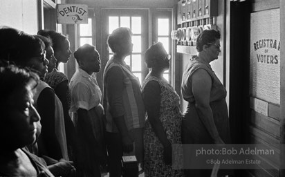A study in impatient patience, voter applicants line up then wait — and wait and wait — to register,  Clinton,  Louisiana.  1964