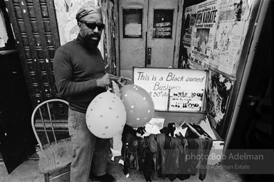 Black enterprise: A peddler displays his wares in a doorway on 125th Street,  Harlem, New York City.
1968