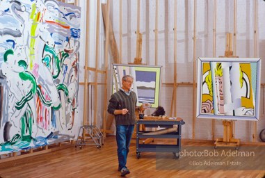 Roy Lichtenstein works on his Reflections series of paintings-His brushstroke painting  'Laocoon' in background. 1989. photo:©Bob Adelman Estate, Artwork©Estate of Roy Lichtenstein