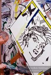 Roy Lichtenstein painting 'Reflections:Wonder Woman (his brushstroke painting 'Laocoon' visible in background).1989. photo:©Bob Adelman Estate, Artwork©Estate of Roy Lichtenstein