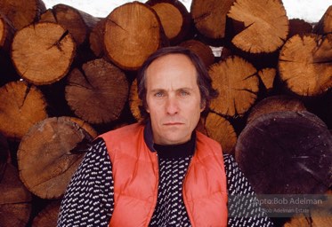 Portrait of the author Richard Ford  at his home in Missoula, Montana in front of chopped wood, 1987.