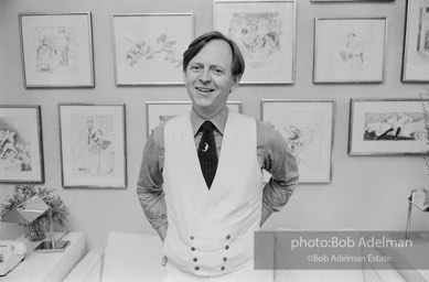 Tom Wolfe in his New York City apartment on the Upper East Side in front of a wall of his drawings.