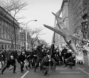 Marchers and onlookers, both for and against the war in Vietnam. Near Central Park in New York City.