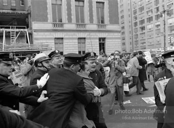 Marchers and onlookers, both for and against the war in Vietnam. Near Central Park in New York City.